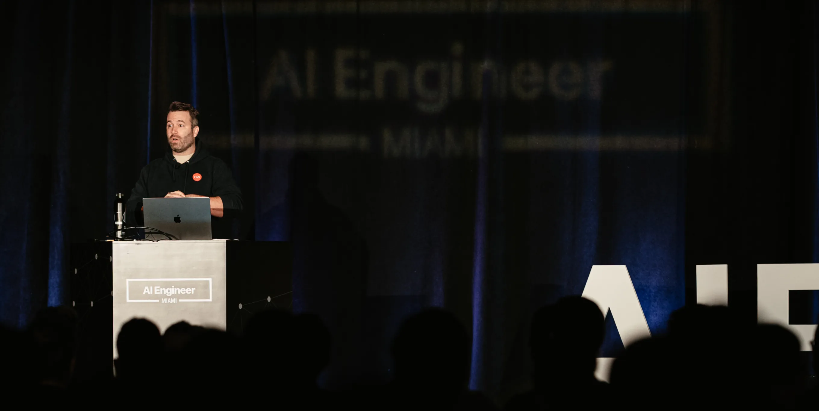 G2i founder speaking at the AI Engineer conference