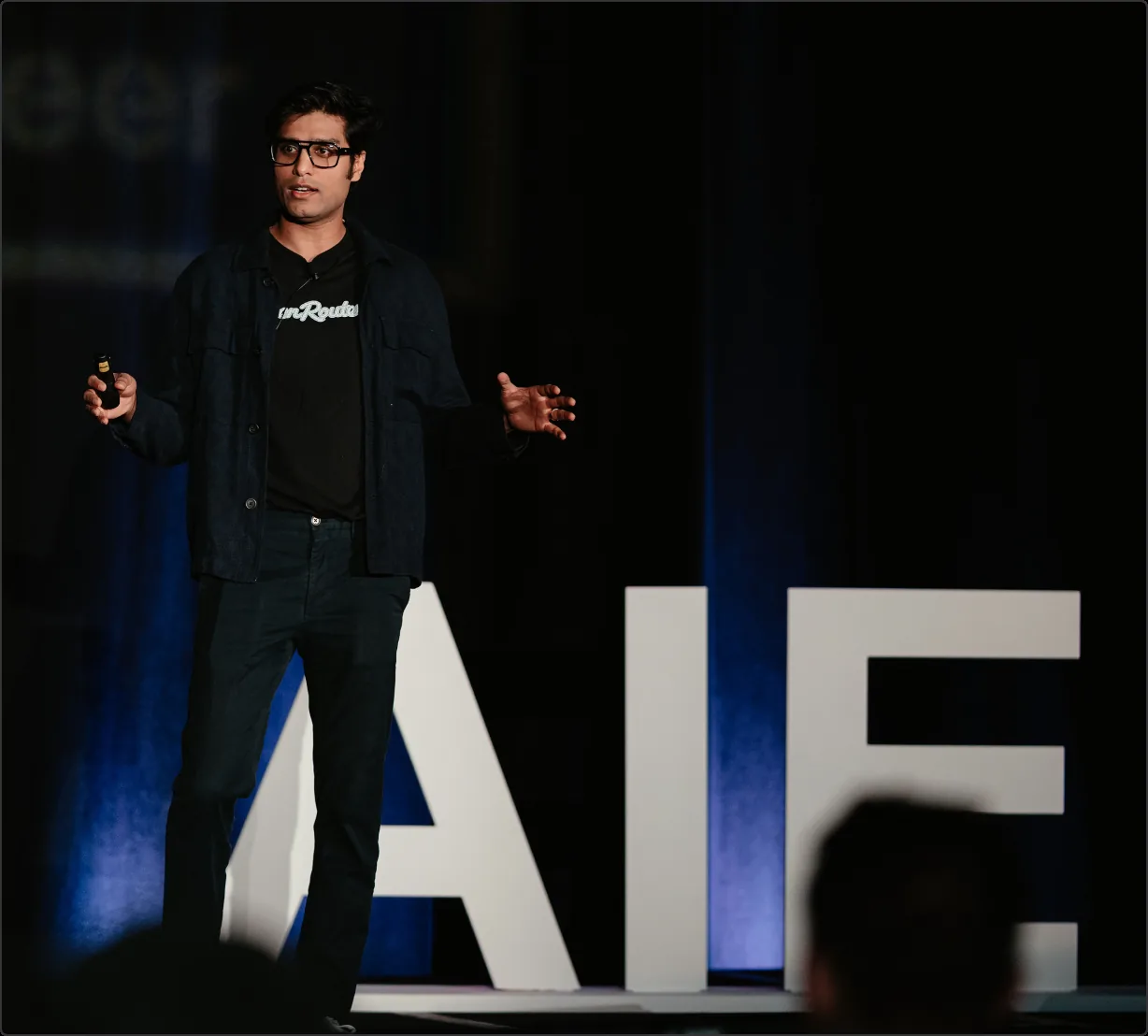 Speaker presenting on stage at a G2i conference